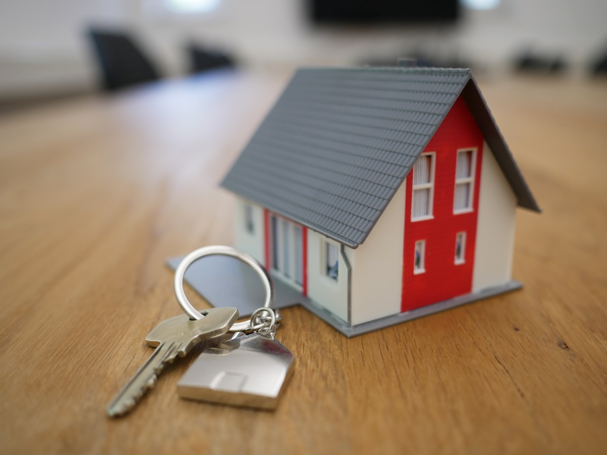 First-time homebuyer reviewing mortgage documents and a budget worksheet at a kitchen table